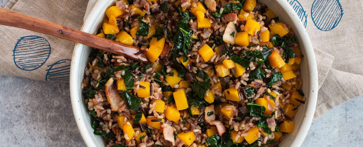 Large serving bowl of wild rice with a wooden serving spoon