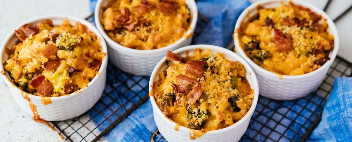 Four small white bowls of food
