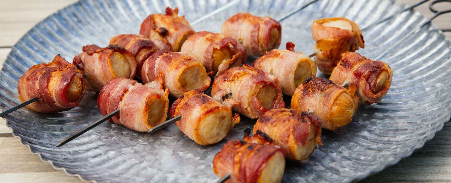 Grilled Bacon Wrapped Sausages with Spicy Avocado Dip
