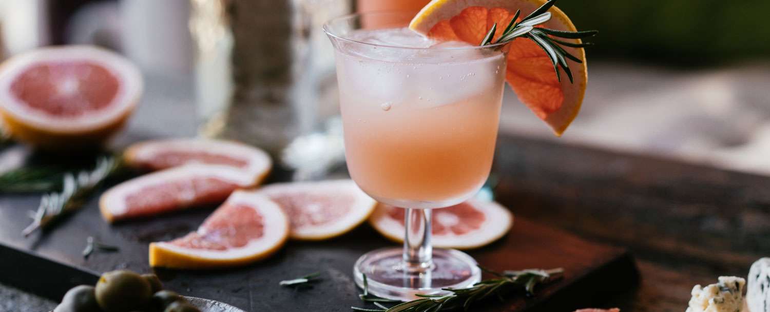 Glass of Paloma garnished with a grapefruit